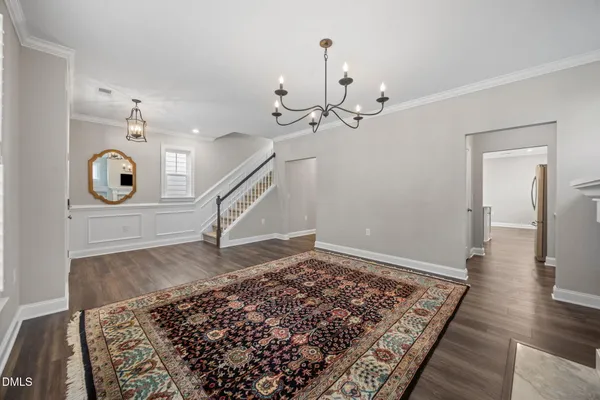 a living room with a fireplace and a rug
