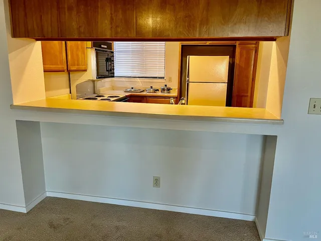an empty room with a fireplace and window