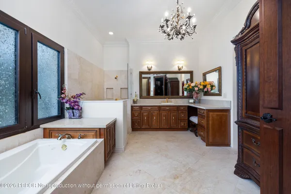a large spacious bathroom with a tub sink and mirror