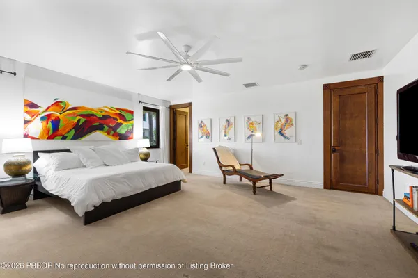 a bedroom with a bed and a couch