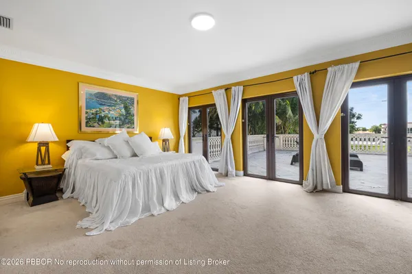 a spacious bedroom with a bed and a large window