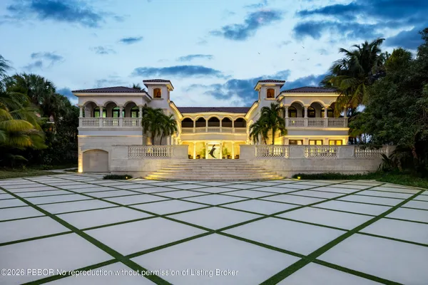 a front view of a building with a garden