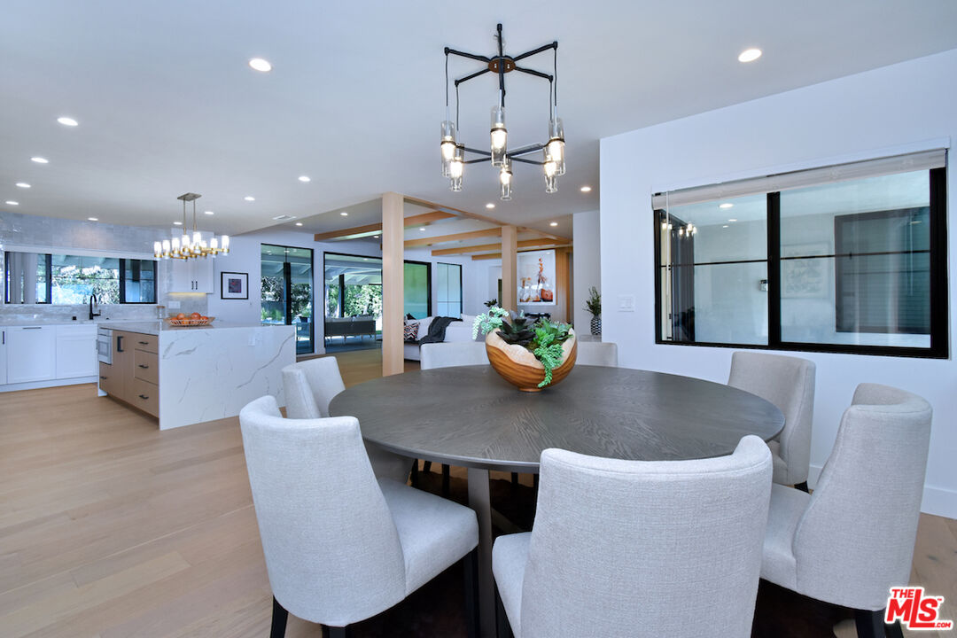 2037 Stradella Road Los Angeles, CA 90077 - Photo 11 of 33 a view of a dining room with furniture and a potted plant