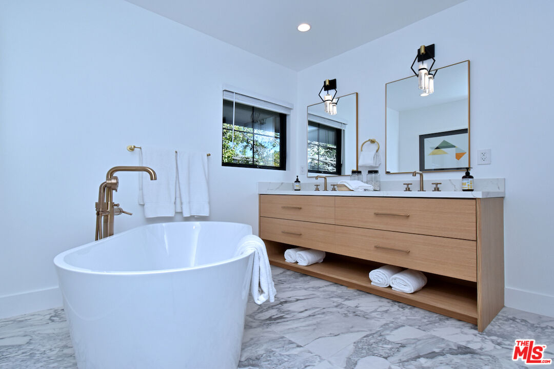 2037 Stradella Road Los Angeles, CA 90077 - Photo 14 of 33 a bathroom with a tub sink and mirror