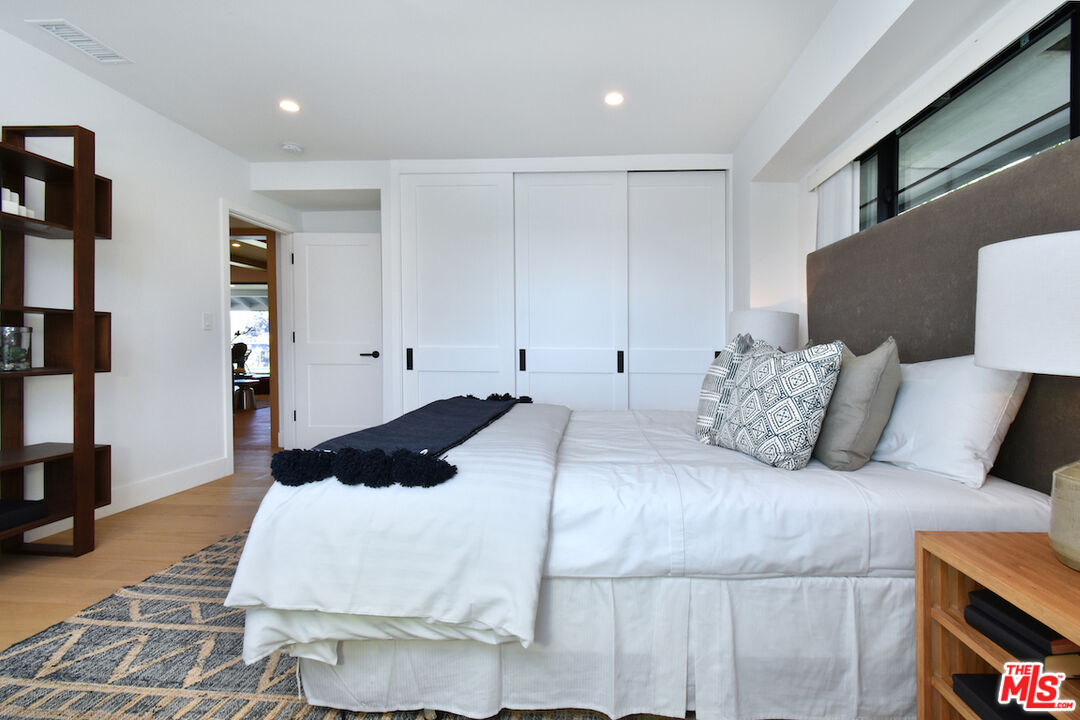 2037 Stradella Road Los Angeles, CA 90077 - Photo 17 of 33 a bedroom with a large bed and a couch