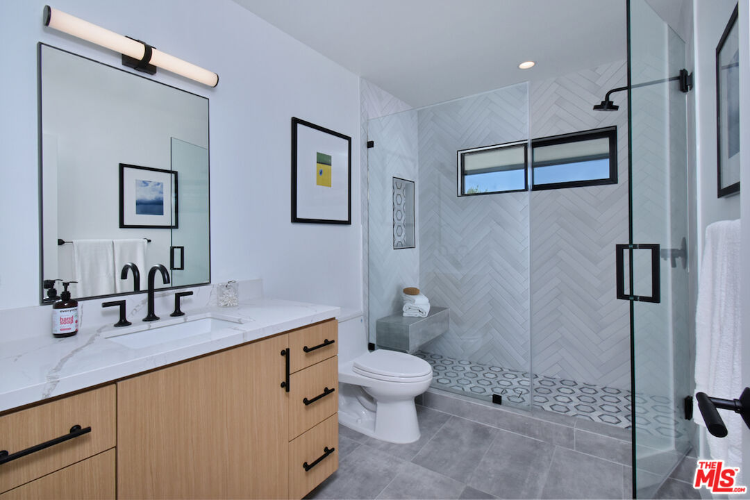 2037 Stradella Road Los Angeles, CA 90077 - Photo 20 of 33 a bathroom with a granite countertop sink toilet and shower