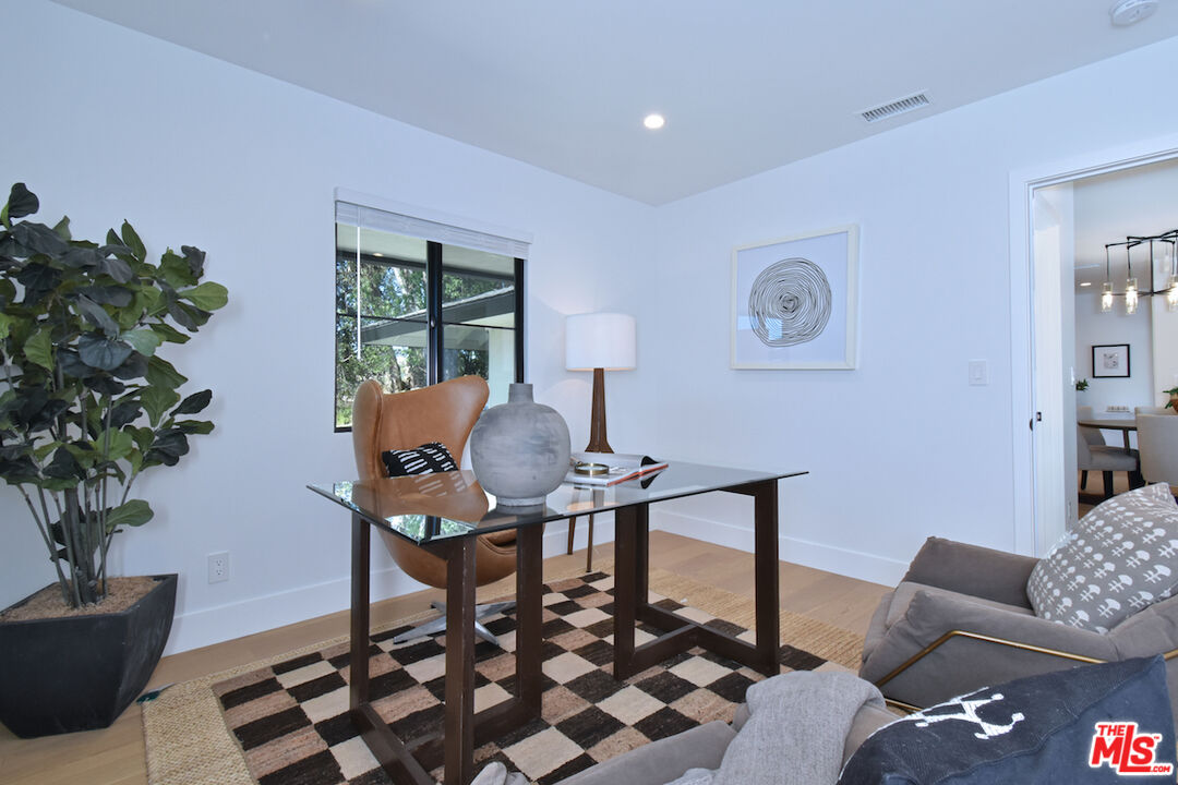 2037 Stradella Road Los Angeles, CA 90077 - Photo 22 of 33 a workspace with furniture and a potted plant
