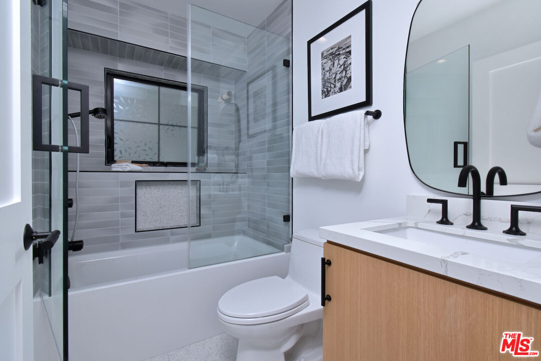 2037 Stradella Road Los Angeles, CA 90077 - Photo 23 of 33 a bathroom with a sink a toilet and shower