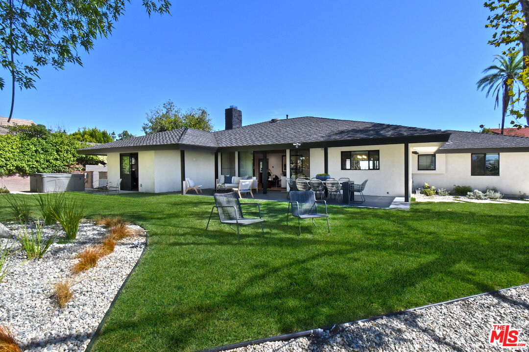 2037 Stradella Road Los Angeles, CA 90077 - Photo 26 of 33 a front view of a house with a garden