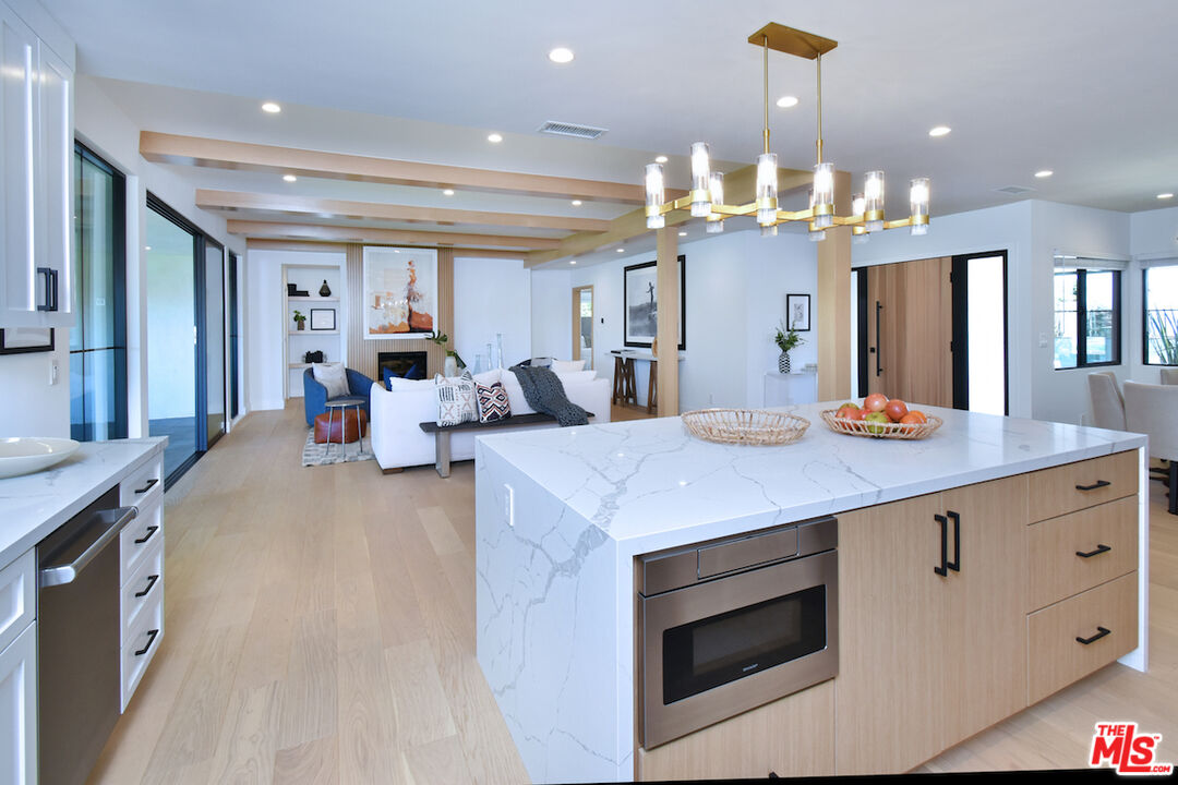 2037 Stradella Road Los Angeles, CA 90077 - Photo 6 of 33 a large kitchen with granite countertop a large stove top oven a sink a counter space and cabinets