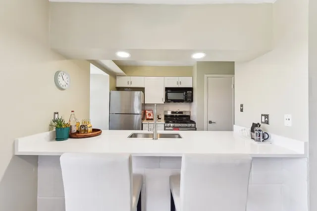 a kitchen with stainless steel appliances a sink and cabinets