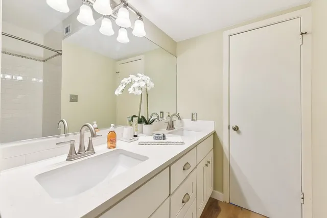 a bathroom with a sink double vanity and a mirror