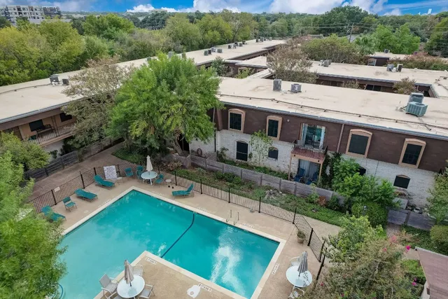 a view of a house with swimming pool and sitting area