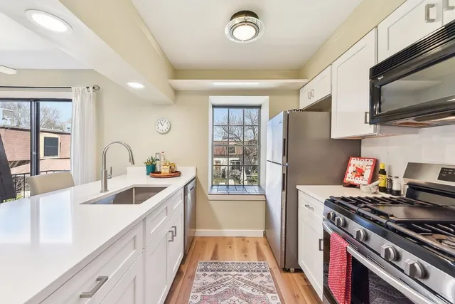 a kitchen with granite countertop a stove and a sink