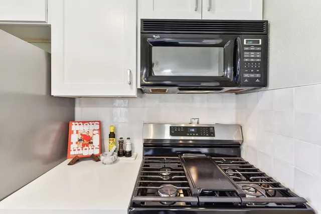 a kitchen with a stove and a microwave