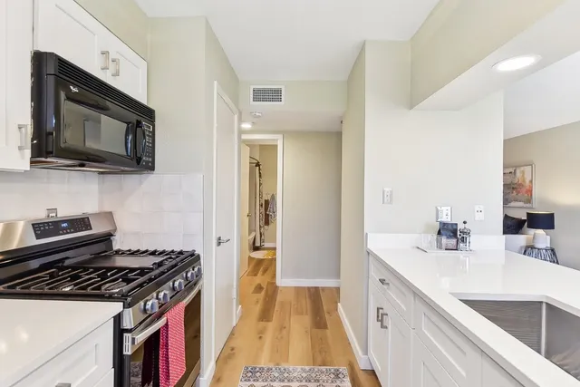 a kitchen with a sink stove and microwave