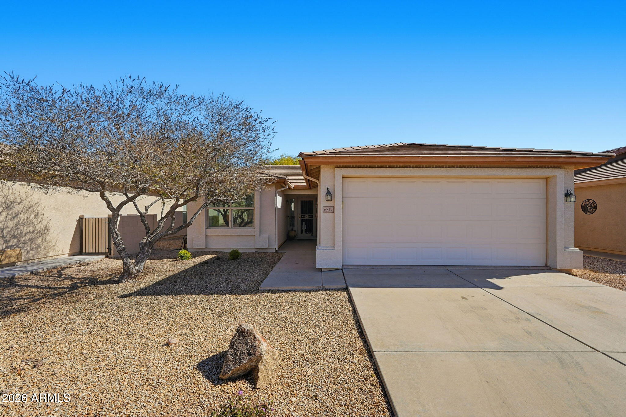 6317 South Pinaleno Place Chandler, AZ 85249 - Photo 1 of 45 a front view of a house with a yard