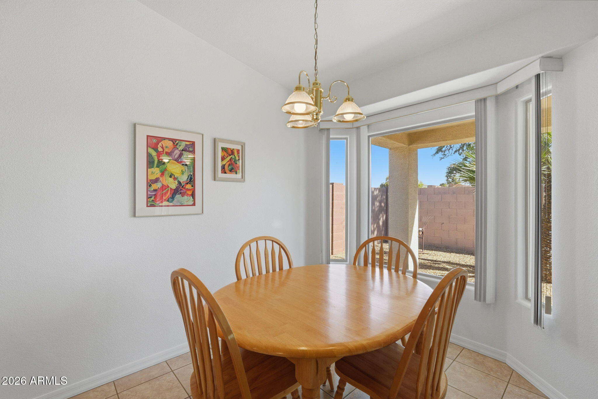 6317 South Pinaleno Place Chandler, AZ 85249 - Photo 13 of 45 a view of a dining room with furniture window and wooden floor