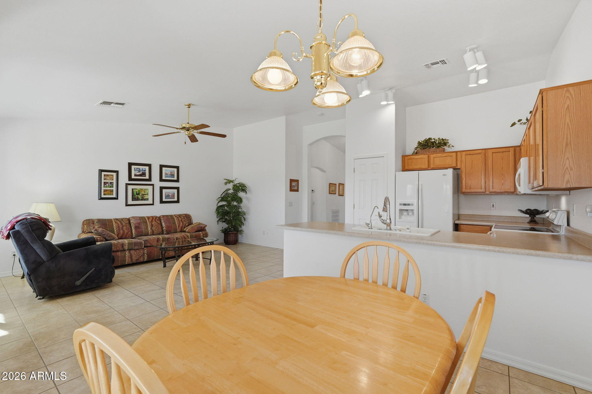 6317 South Pinaleno Place Chandler, AZ 85249 - Photo 14 of 45 a view of a dining room with furniture and chandelier