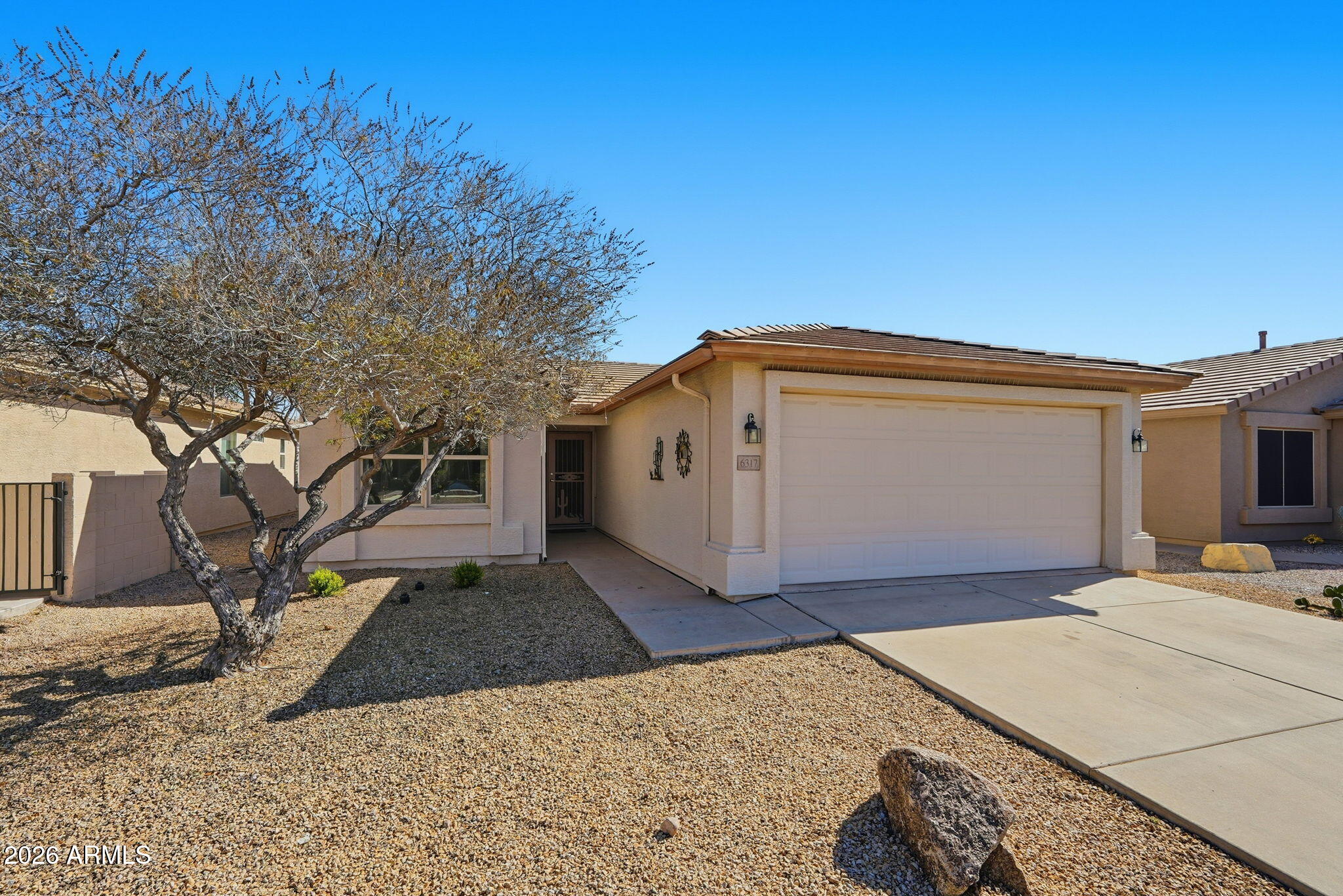 6317 South Pinaleno Place Chandler, AZ 85249 - Photo 2 of 45 a view of a house with a snow in the yard
