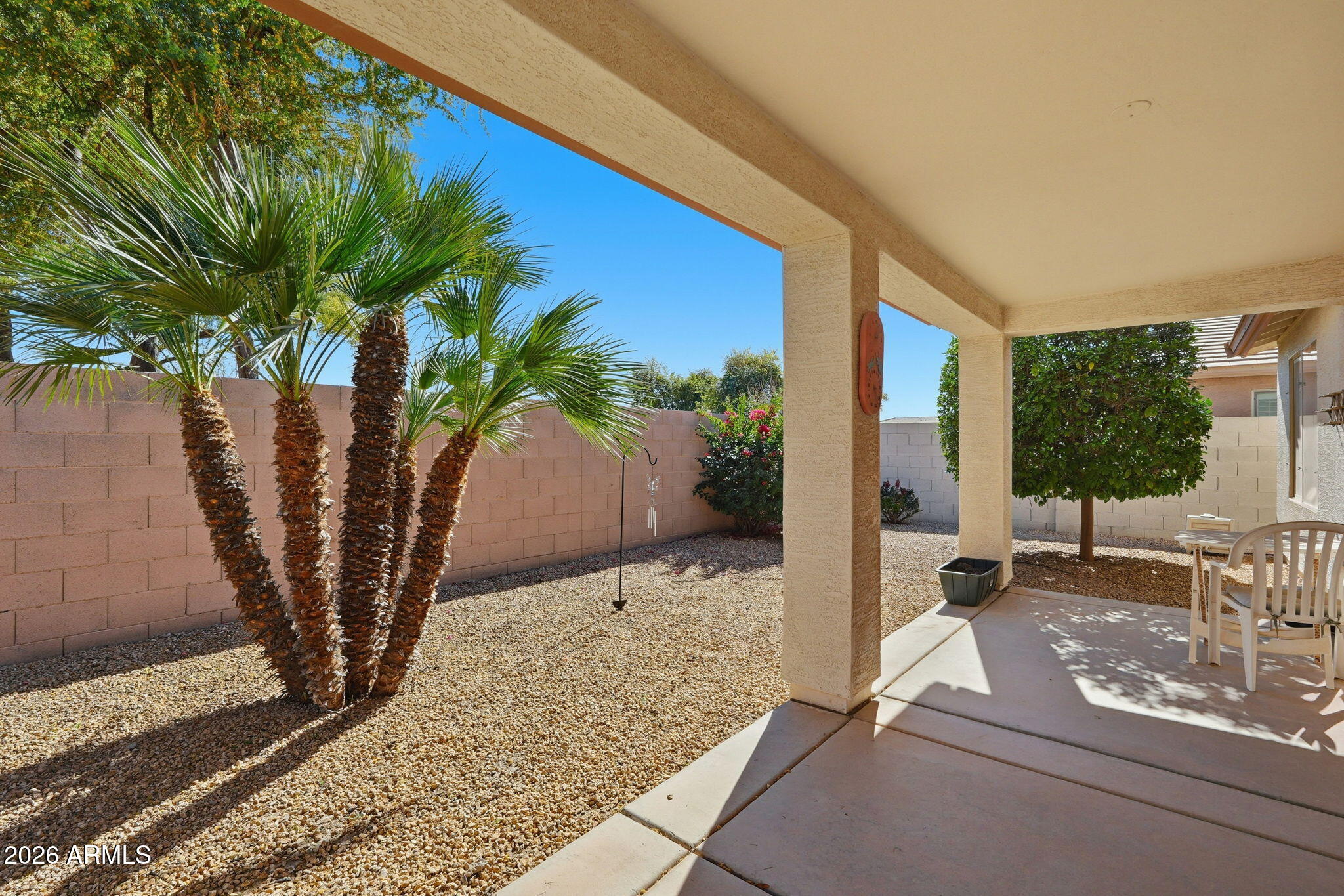 6317 South Pinaleno Place Chandler, AZ 85249 - Photo 24 of 45 a view of a porch with chairs and potted plants