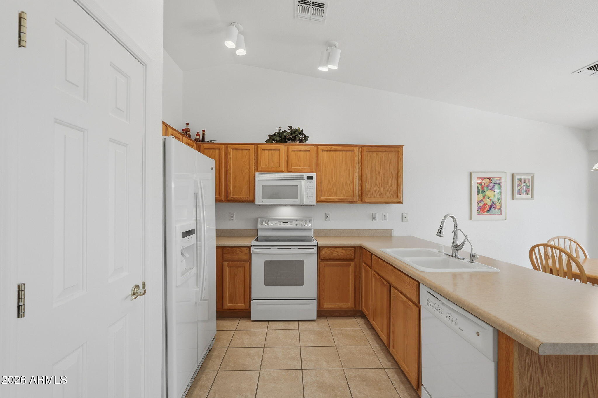 6317 South Pinaleno Place Chandler, AZ 85249 - Photo 8 of 45 a kitchen with stainless steel appliances granite countertop a sink and cabinets