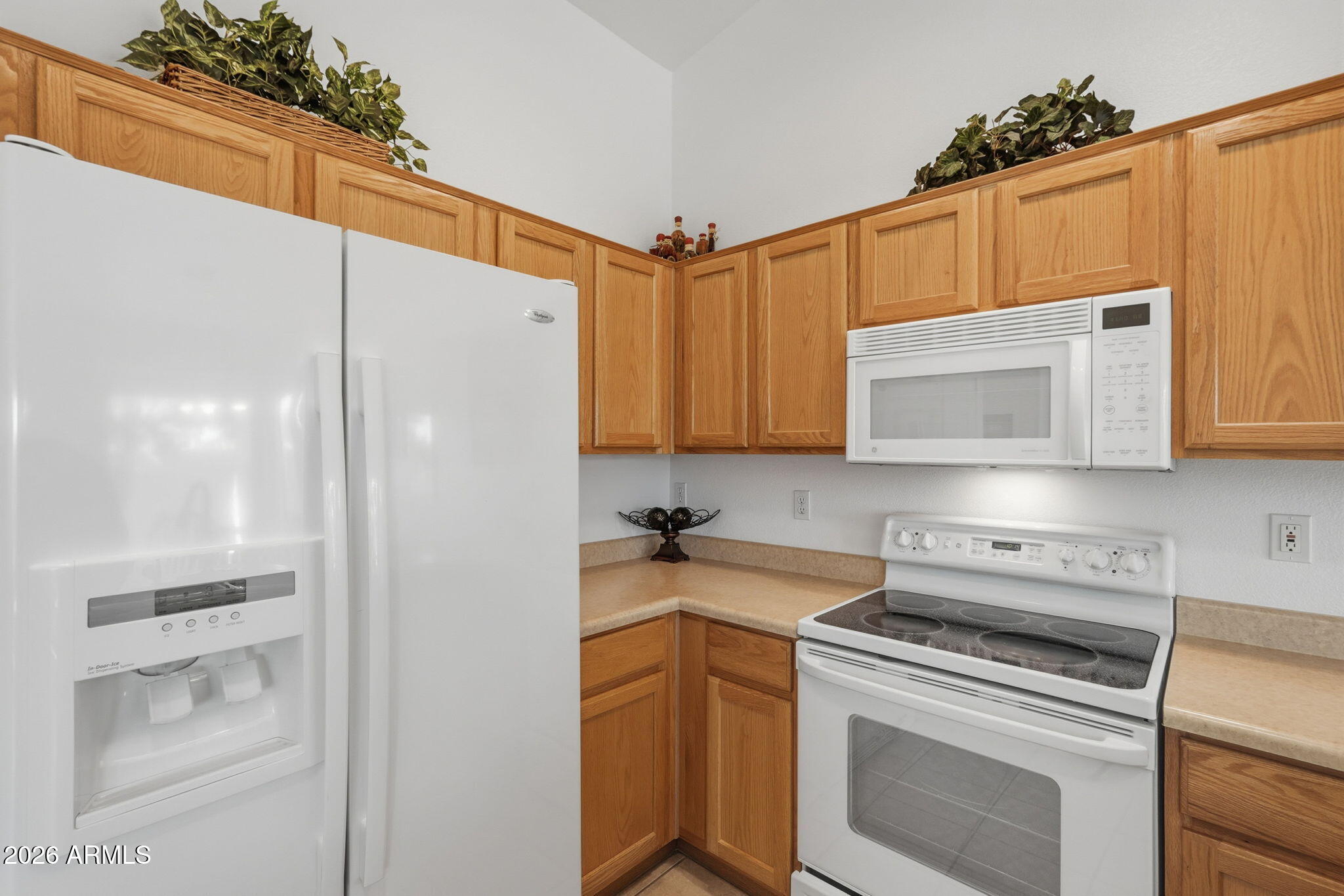 6317 South Pinaleno Place Chandler, AZ 85249 - Photo 10 of 45 a kitchen with a sink a stove and cabinets