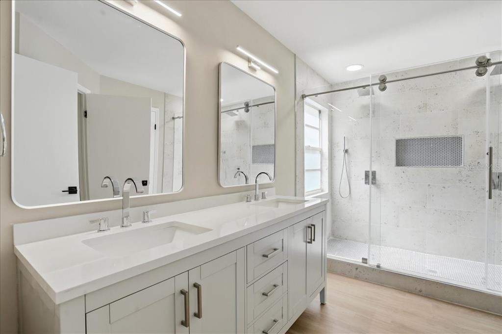 1723 Elk Spring Drive Brandon, FL 33511 - Photo 12 of 21 a bathroom with a shower sink vanity and mirror