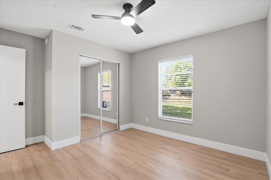 1723 Elk Spring Drive Brandon, FL 33511 - Photo 16 of 21 an empty room with wooden floor ceiling fan and windows