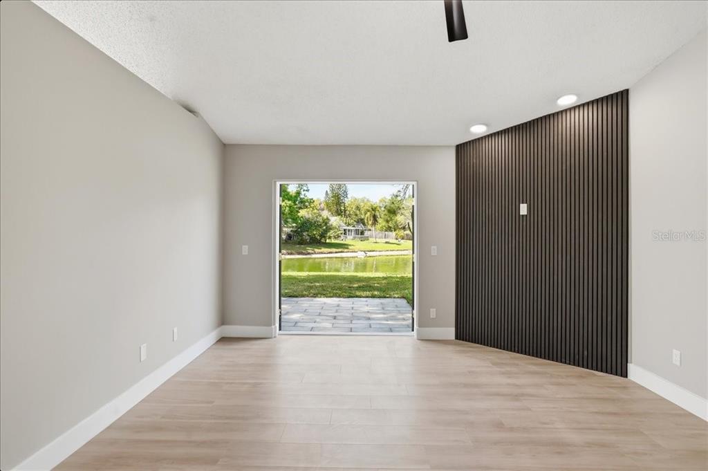 1723 Elk Spring Drive Brandon, FL 33511 - Photo 3 of 21 a view of an empty room with wooden floor and a window