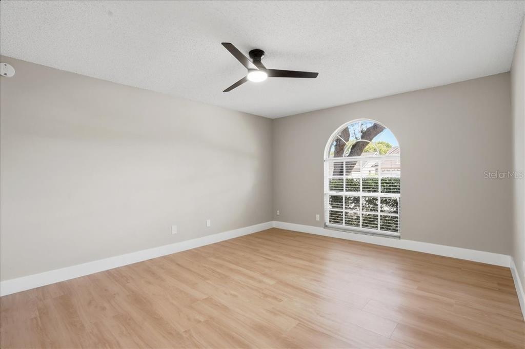 1723 Elk Spring Drive Brandon, FL 33511 - Photo 10 of 21 an empty room with wooden floor fan and windows
