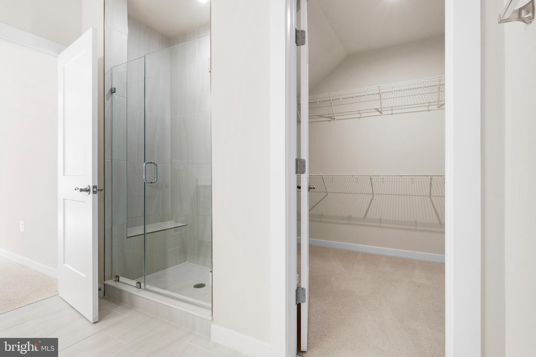 44487 Wolfhound Square Ashburn, VA 20147 - Photo 15 of 39 a bathroom with a glass shower door