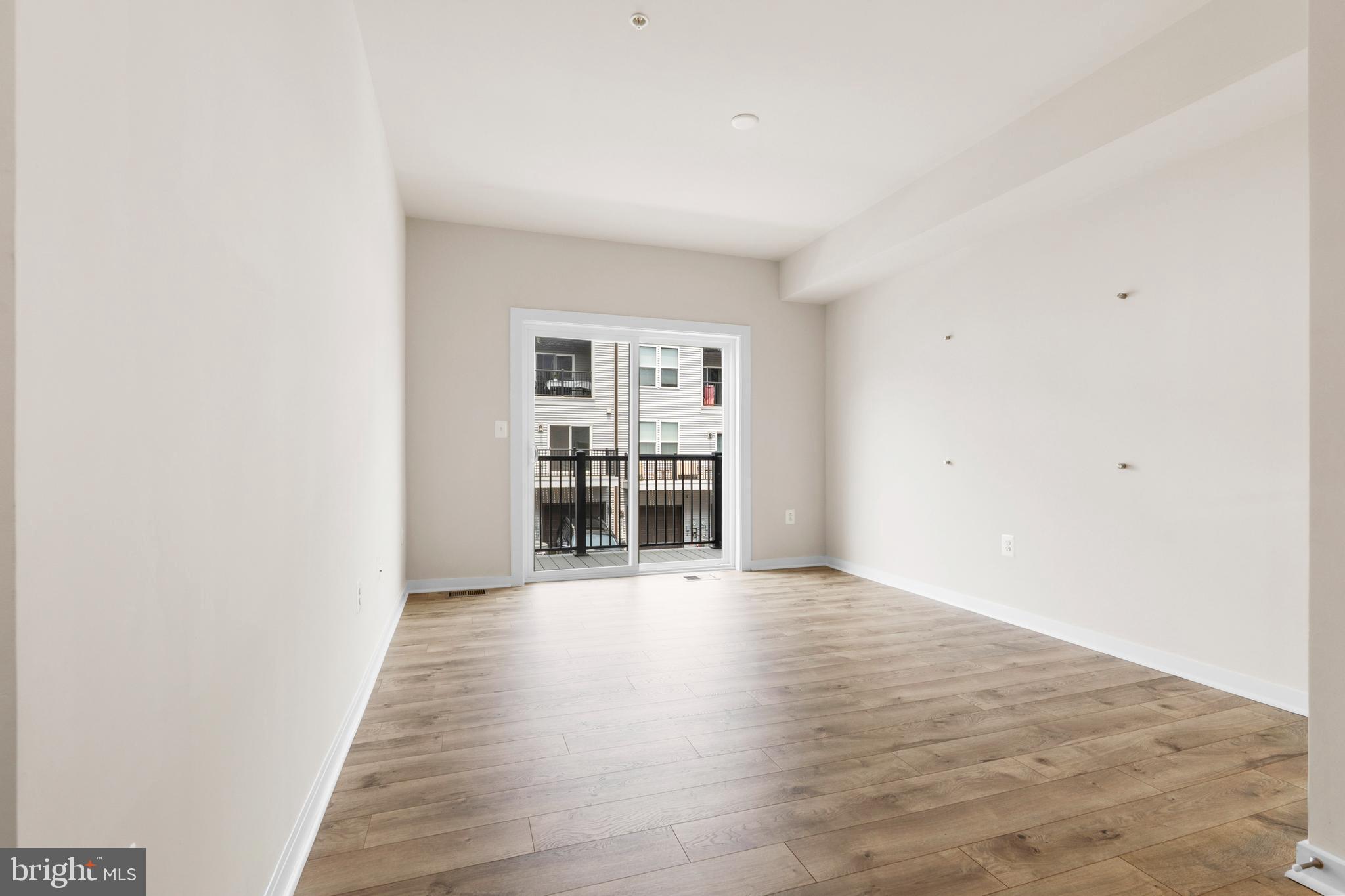 44487 Wolfhound Square Ashburn, VA 20147 - Photo 19 of 39 an empty room with wooden floor and windows