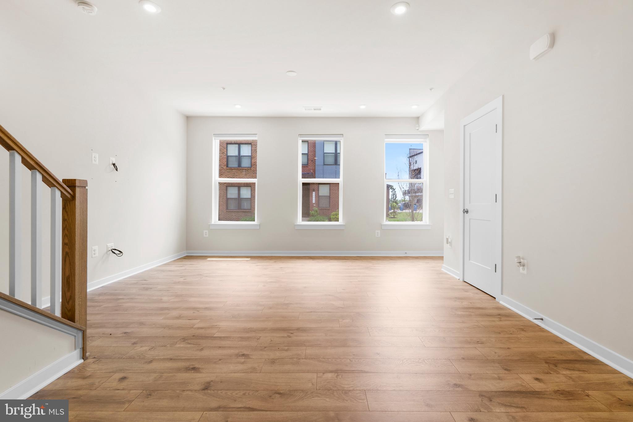 44487 Wolfhound Square Ashburn, VA 20147 - Photo 9 of 39 a view of an empty room with wooden floor and a window