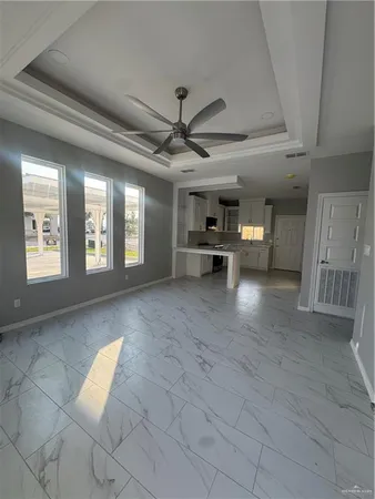 a view of livingroom with a ceiling fan and window