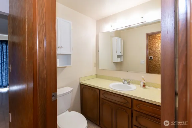 a bathroom with a toilet sink and mirror