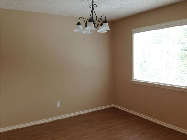 a view of a small space with wooden floor and a window