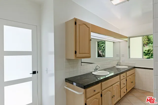 a bathroom with a shower and a glass door