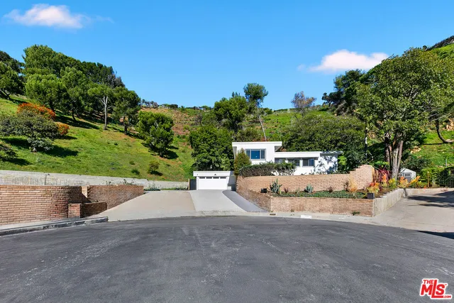 a view of a park with plants and a bench