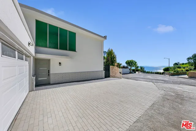 a house with a yard and potted plants