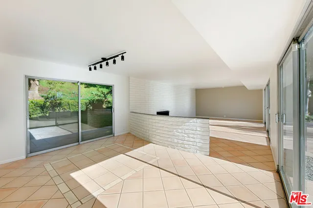 a bedroom with a bed and a chair