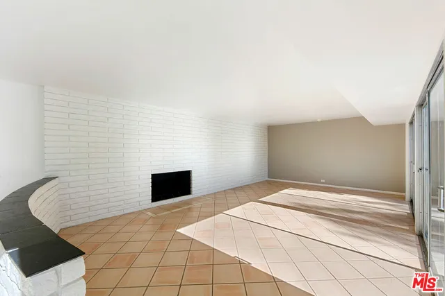 a living room with a large window and furniture