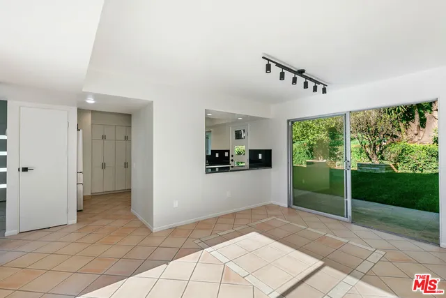 a kitchen with granite countertop a sink a stove and cabinets