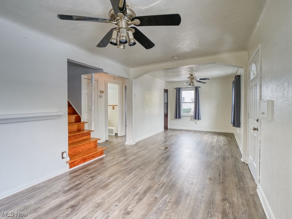 3774 Highland Road Cleveland, OH 44111 - Photo 10 of 31 Empty room with light wood-type flooring, ceiling fan, and a textured ceiling