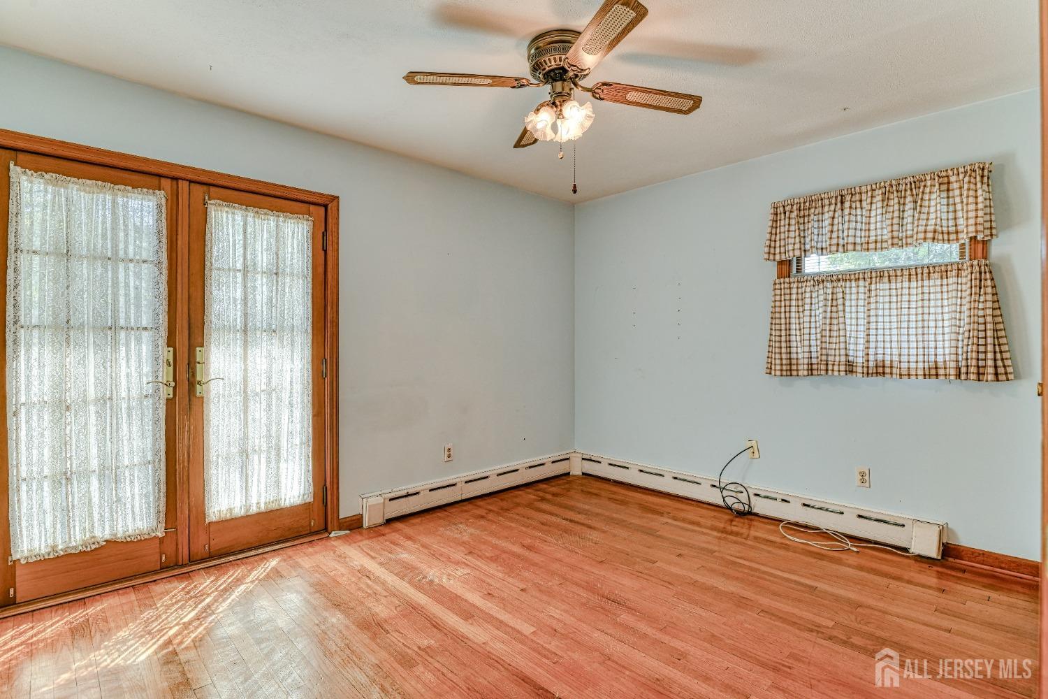 79 South Hill Road Colonia, NJ 07067 - Photo 15 of 34 a view of an empty room with a window and wooden floor