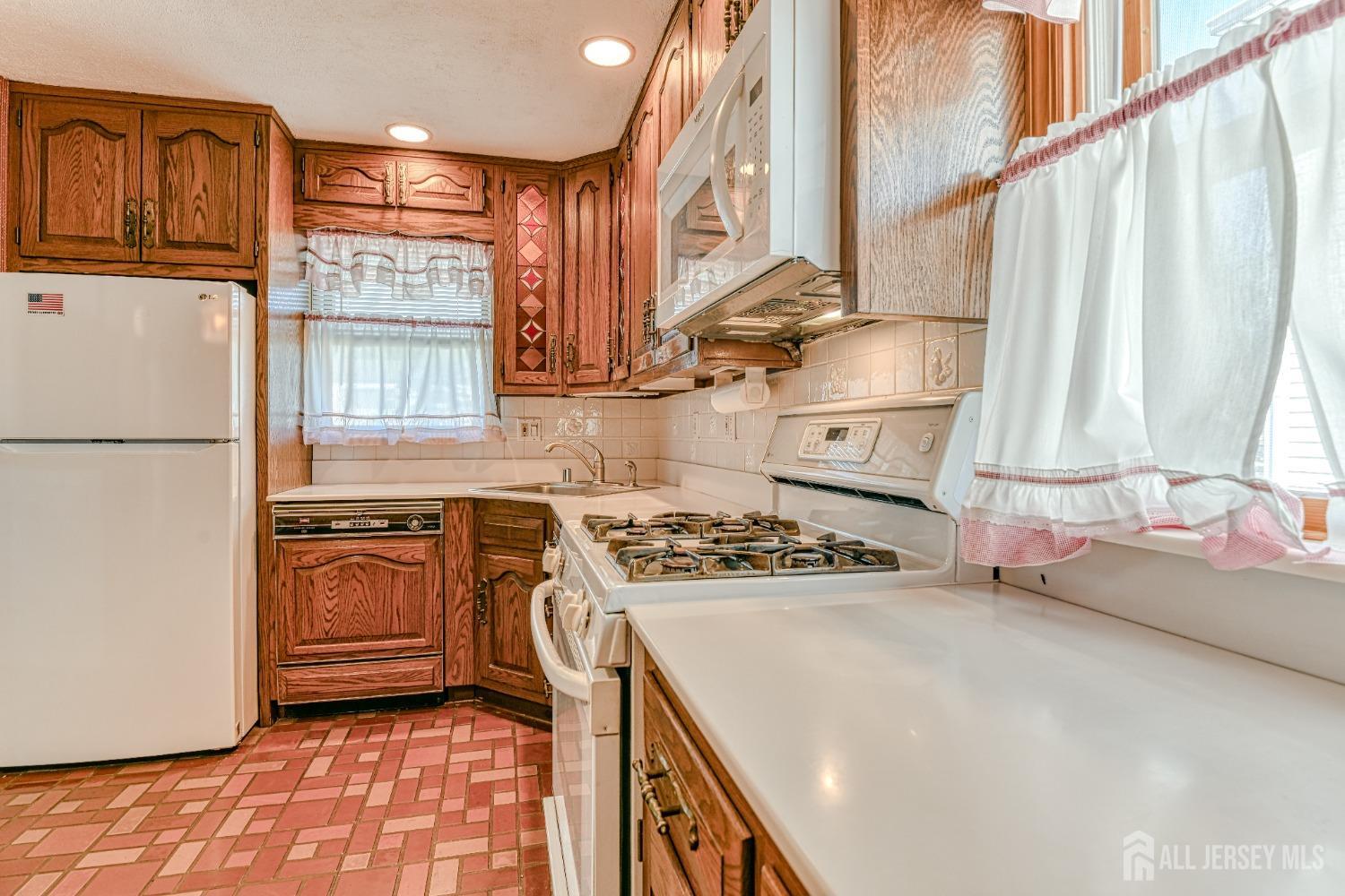 79 South Hill Road Colonia, NJ 07067 - Photo 8 of 34 a kitchen with stainless steel appliances granite countertop a stove a sink and a refrigerator