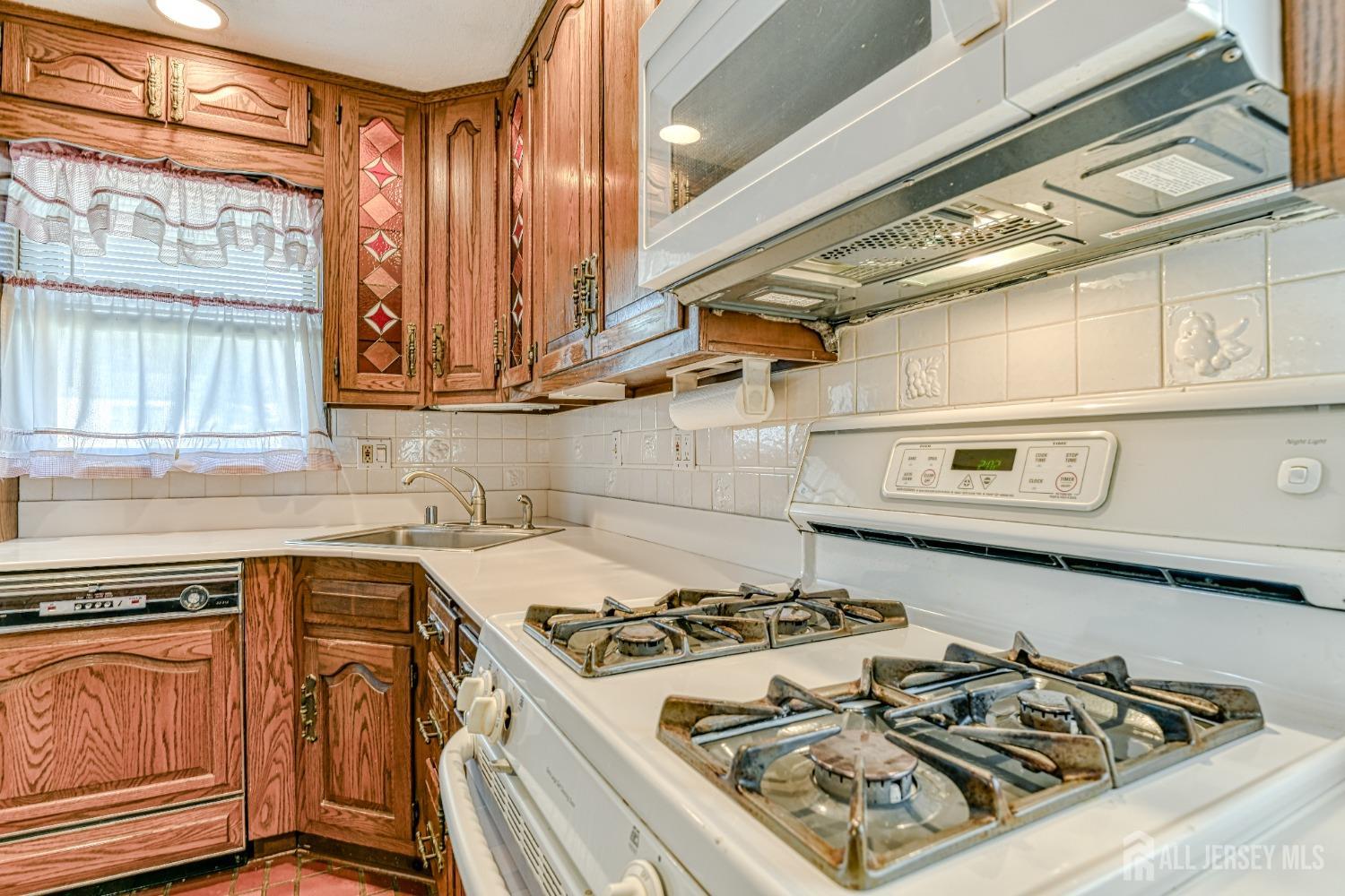 79 South Hill Road Colonia, NJ 07067 - Photo 9 of 34 a white stove top oven sitting inside of a kitchen