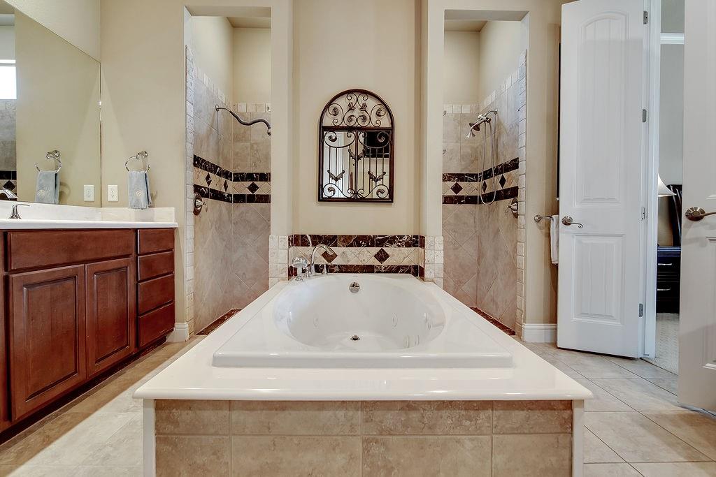 117 Citation Drive Cresson, TX 76035 - Photo 22 of 40 Full bathroom featuring a garden tub, light tile patterned floors, and vanity