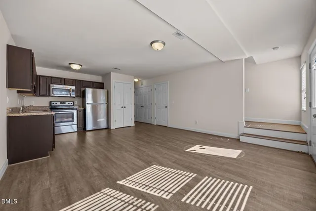 a view of kitchen with furniture and wooden floor