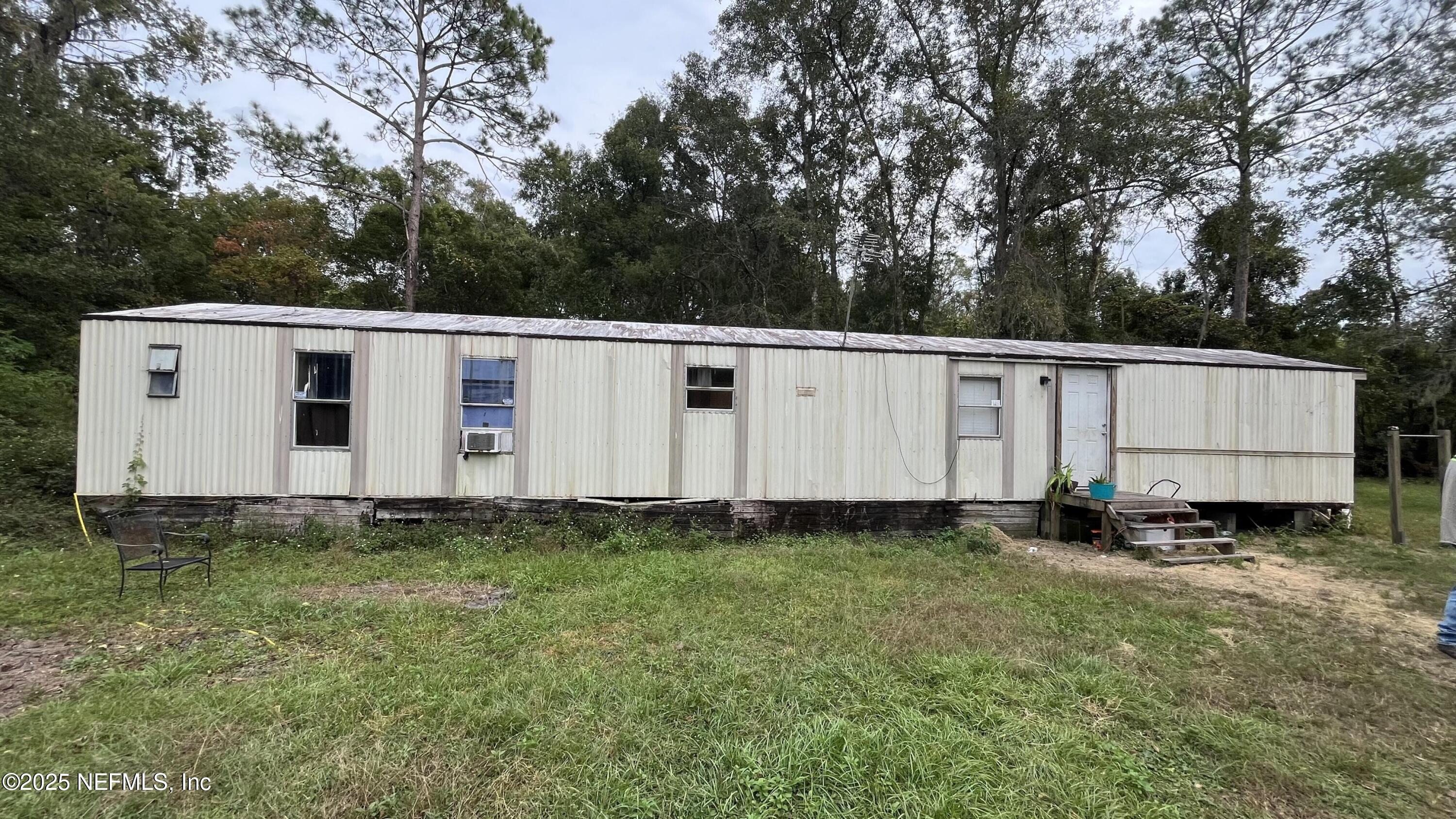 10017 Factory Avenue Hampton, FL 32044 - Photo 1 of 11 a view of a small yard with white house